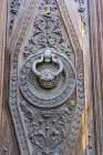 Albaicin, Province of Granada, Andalusia, Spain. Ornate metal knocker on a carved wooden door. Art Print